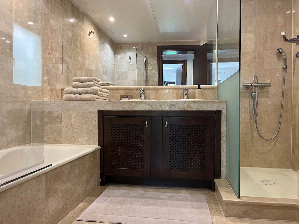 Marble bathroom with bathtub and walk-in shower