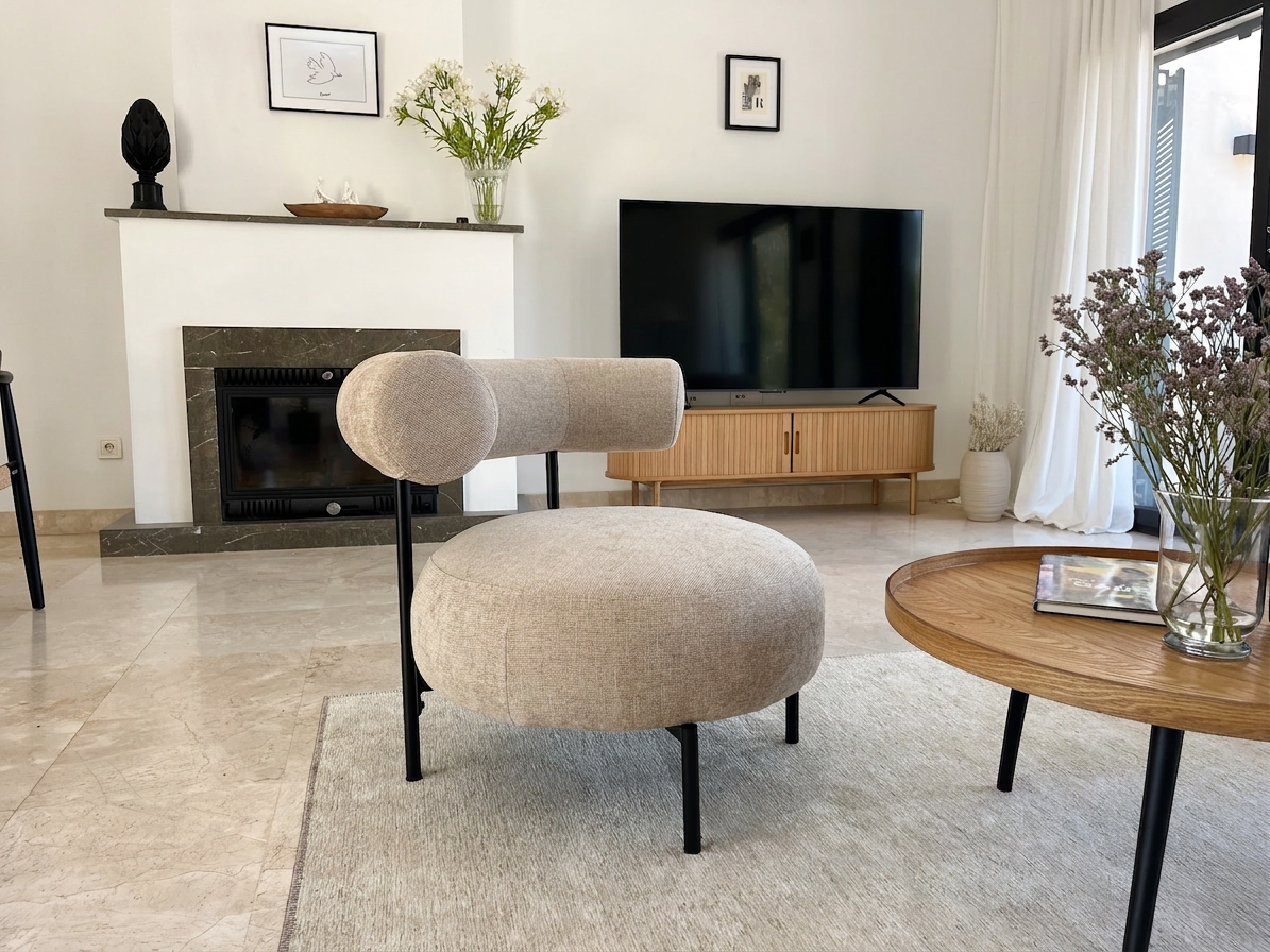 Bouclé lounge chair by the fireplace